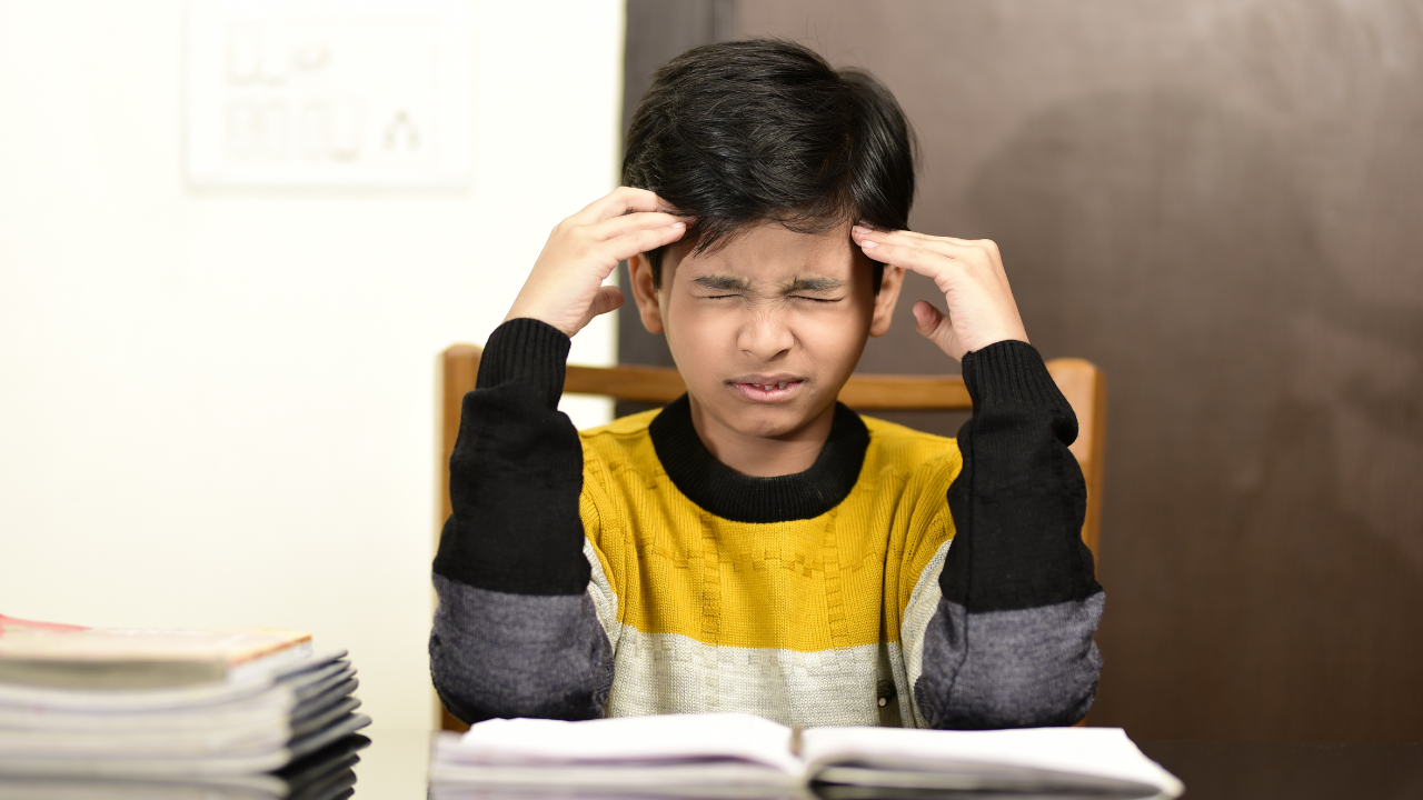 A young male student is feeling stress from increased academic expectations.